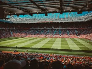 People watching a football game at a stadium
